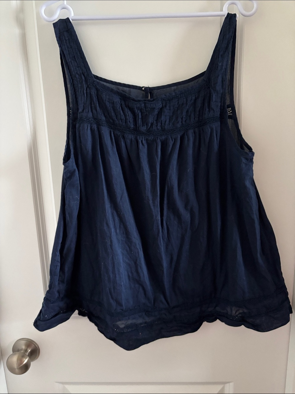 Women’s L Navy sleeveless blouse with intricate stitching and design.